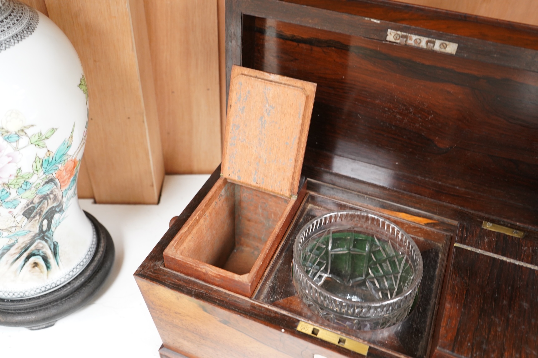 A William IV rosewood sarcophagus shaped tea caddy with glass liner, 33cm wide